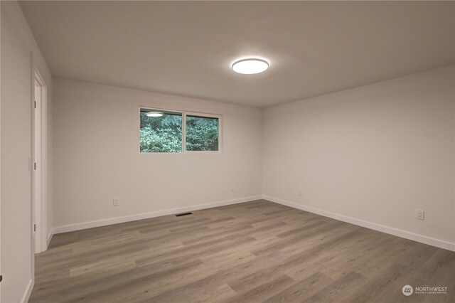 unfurnished room featuring wood-type flooring