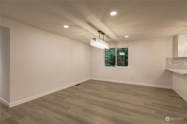 unfurnished dining area featuring dark hardwood / wood-style floors