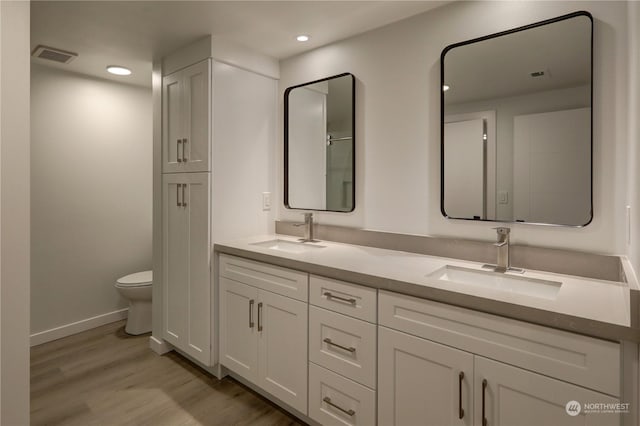34716 169th Ave SE, Auburn, WA 98092 - bathroom with double vanity, wood finished floors, and recessed lighting