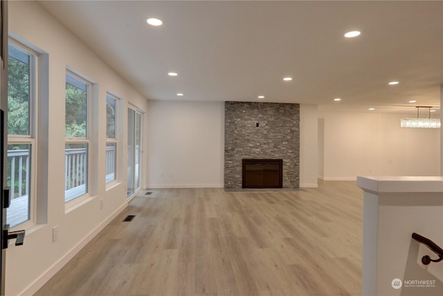 34716 169th Ave SE, Auburn, WA 98092 - unfurnished living room featuring light wood finished floors, recessed lighting, and a stone fireplace