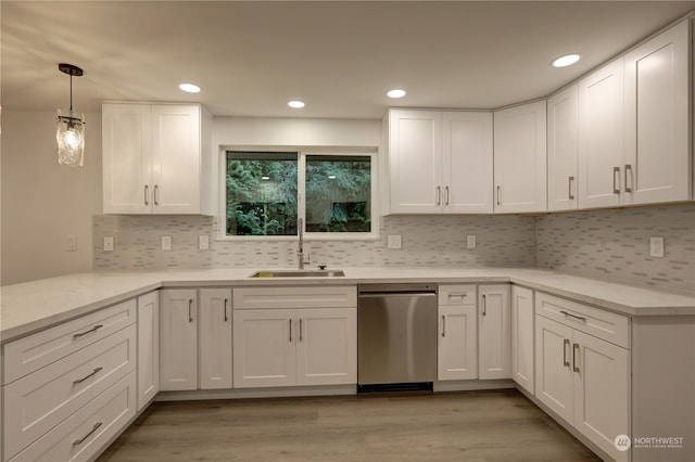 kitchen featuring dishwasher, white cabinetry, and sink