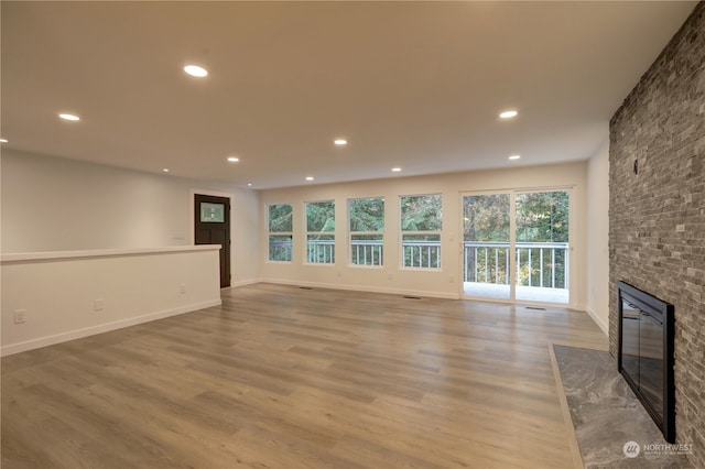 unfurnished living room with hardwood / wood-style flooring and a fireplace