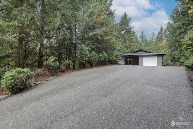 34716 169th Ave SE, Auburn, WA 98092 - view of front of home with asphalt driveway, a wooded view, and a carport