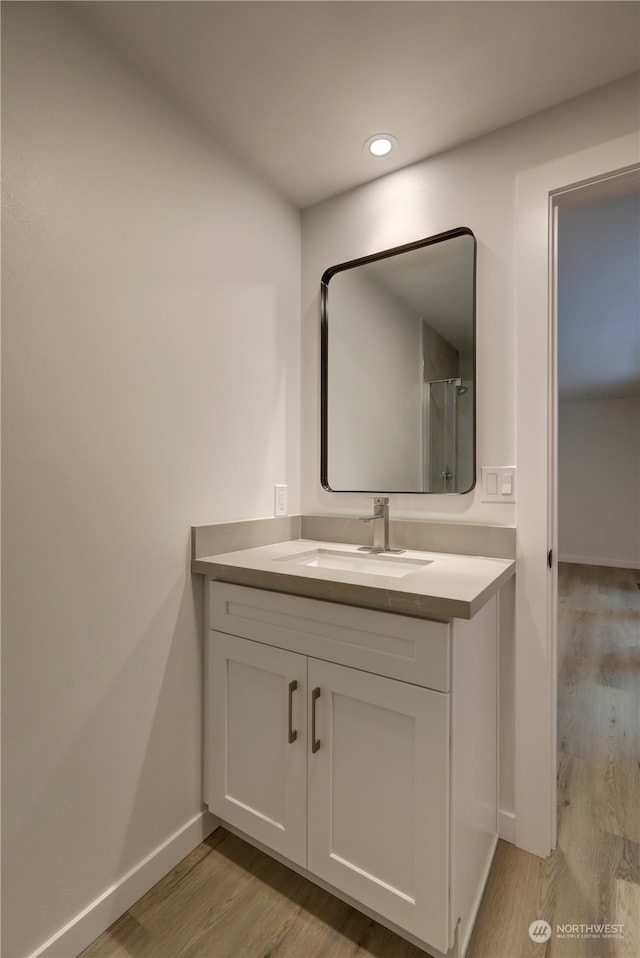 bathroom with vanity and hardwood / wood-style flooring