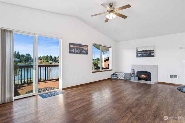 361 Lake View Loop NE, Ocean Shores, WA 98569 - unfurnished living room featuring vaulted ceiling, a ceiling fan, a fireplace with flush hearth, wood finished floors, and baseboards
