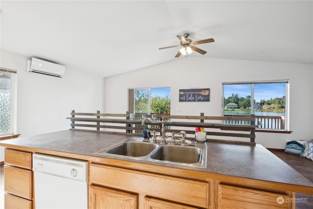 kitchen featuring a wall mounted air conditioner, a wealth of natural light, white dishwasher, and a sink