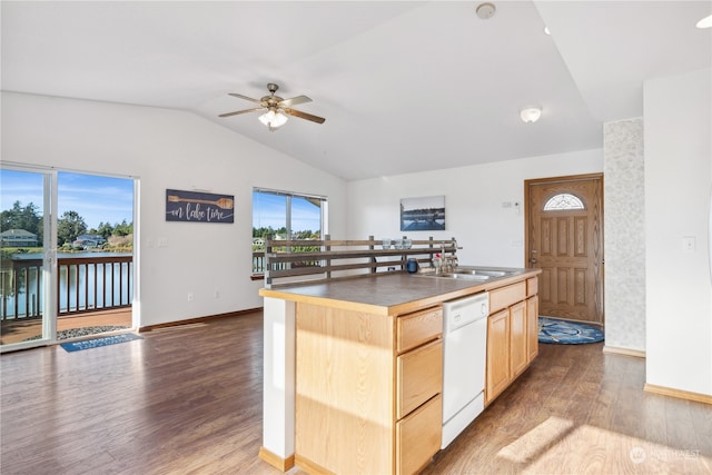 kitchen with light brown cabinets, a sink, wood finished floors, white dishwasher, and lofted ceiling