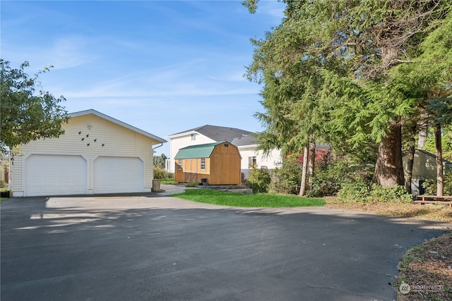 view of front of property with an outdoor structure and a storage unit