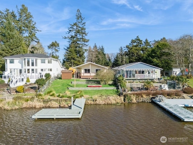 dock area featuring a yard and a water view
