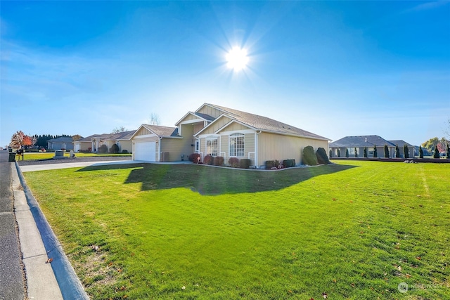 ranch-style home with a garage and a front lawn