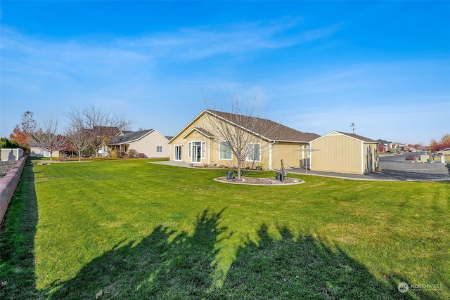 back of property with a garage and a yard