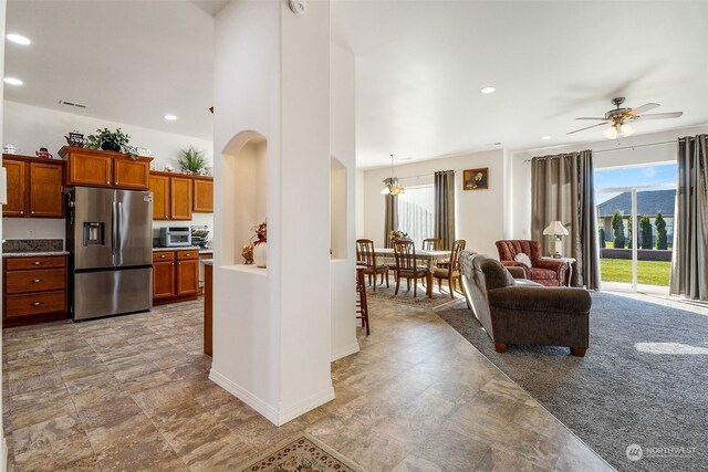 kitchen with stainless steel refrigerator with ice dispenser and ceiling fan