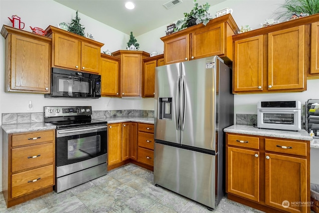 kitchen with light stone countertops and stainless steel appliances