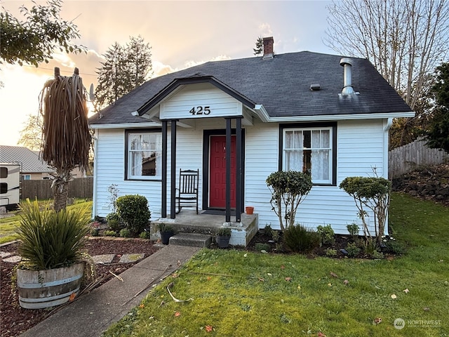 bungalow-style home with a lawn