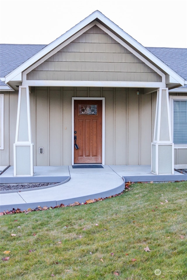 entrance to property with a lawn