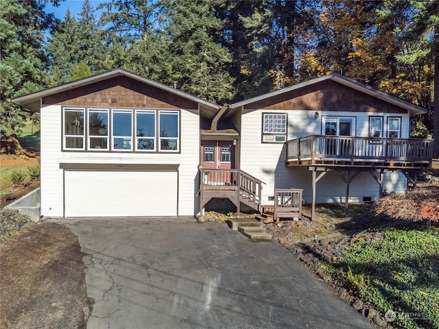 view of front of home with a garage and a deck