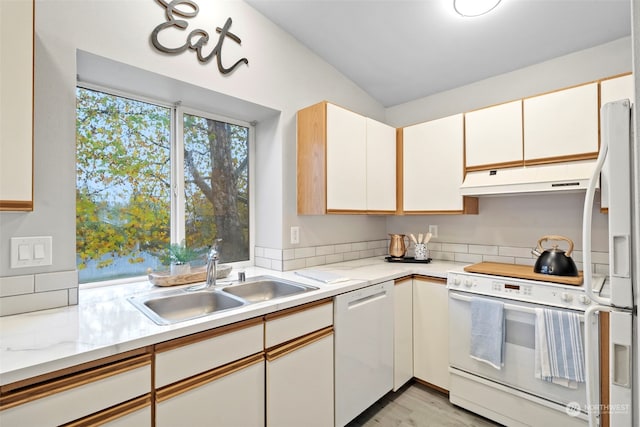 kitchen with white cabinetry, sink, white appliances, light hardwood / wood-style flooring, and lofted ceiling