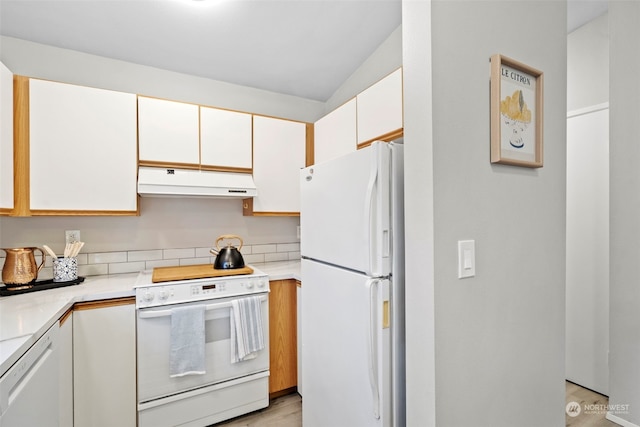 kitchen featuring white cabinets, light hardwood / wood-style floors, and white appliances