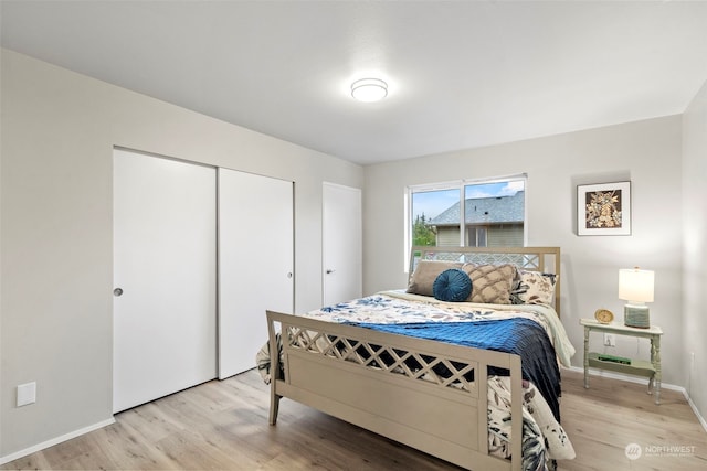 bedroom featuring light wood-type flooring and a closet