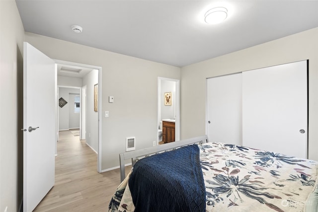 bedroom featuring light hardwood / wood-style floors and a closet