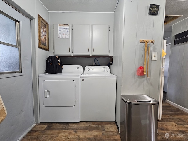 washroom with cabinets, dark hardwood / wood-style flooring, and washing machine and dryer