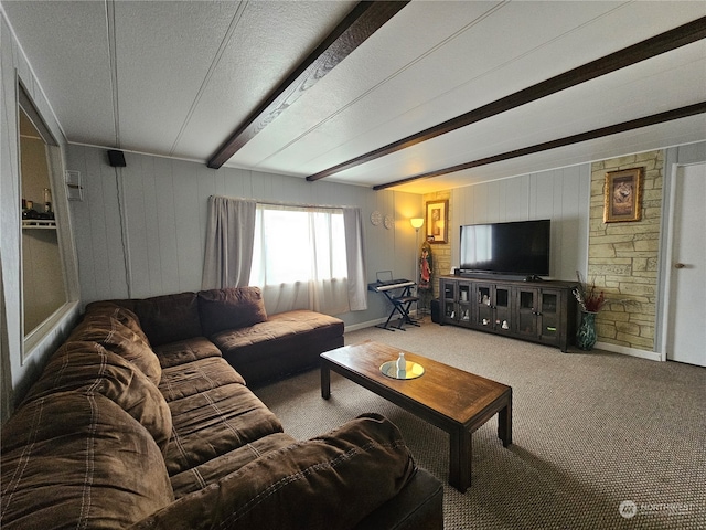 living room featuring beam ceiling, carpet floors, and a textured ceiling