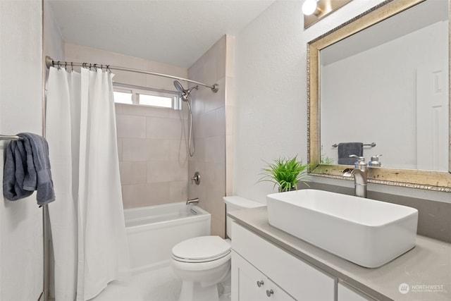 full bathroom with vanity, a textured ceiling, toilet, and shower / tub combo