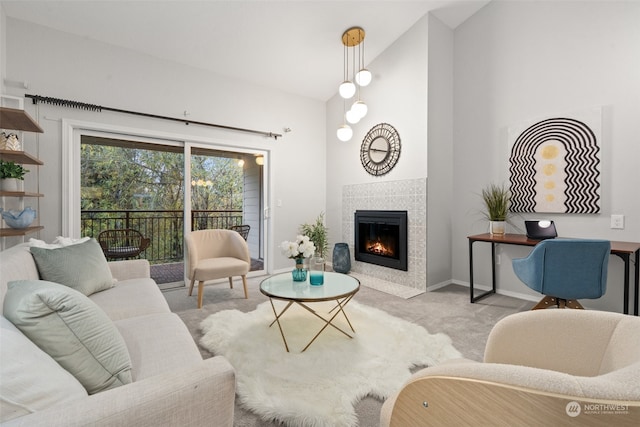 living room featuring lofted ceiling, light colored carpet, and a fireplace