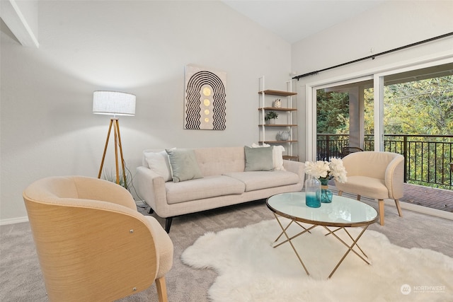 living room with vaulted ceiling and carpet flooring