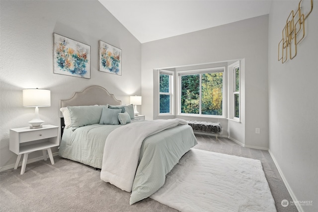 carpeted bedroom with lofted ceiling