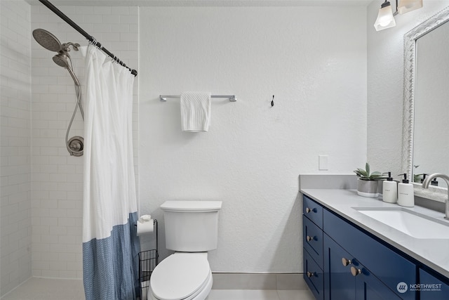 bathroom with tile patterned flooring, vanity, curtained shower, and toilet