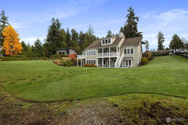 back of house with a lawn