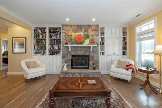 living room featuring a fireplace, hardwood / wood-style floors, and ornamental molding