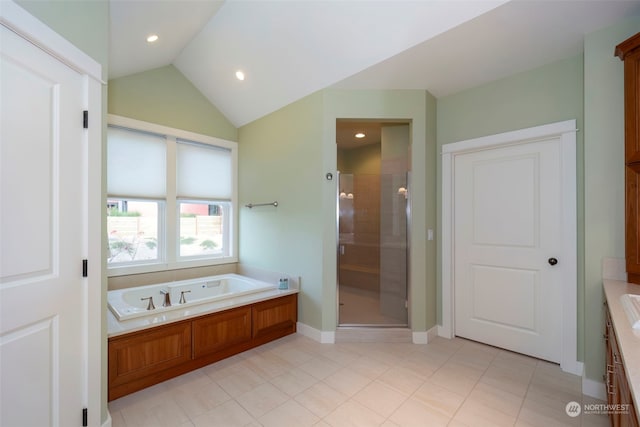 bathroom with tile patterned flooring, independent shower and bath, and vaulted ceiling