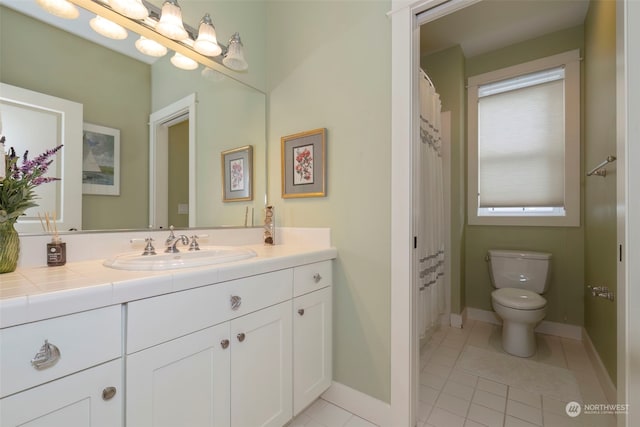 bathroom featuring tile patterned flooring, vanity, and toilet