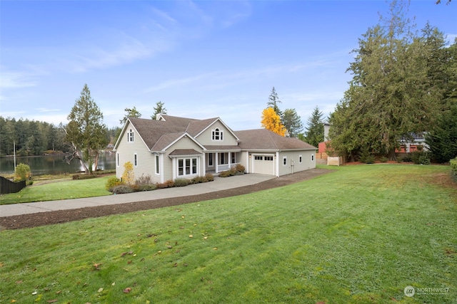 view of front of home featuring a water view, a garage, and a front lawn