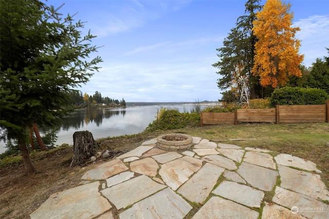 view of patio / terrace featuring a water view and a fire pit