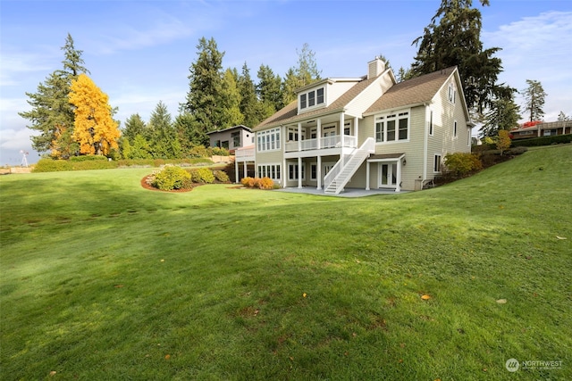 rear view of property featuring a wooden deck and a yard