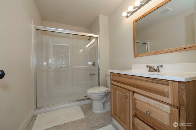 bathroom featuring a shower with door, vanity, and toilet