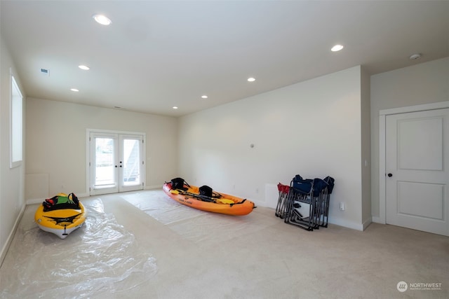 miscellaneous room with light colored carpet and french doors