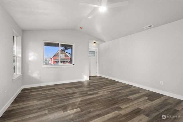 empty room featuring dark hardwood / wood-style flooring, ceiling fan, and vaulted ceiling