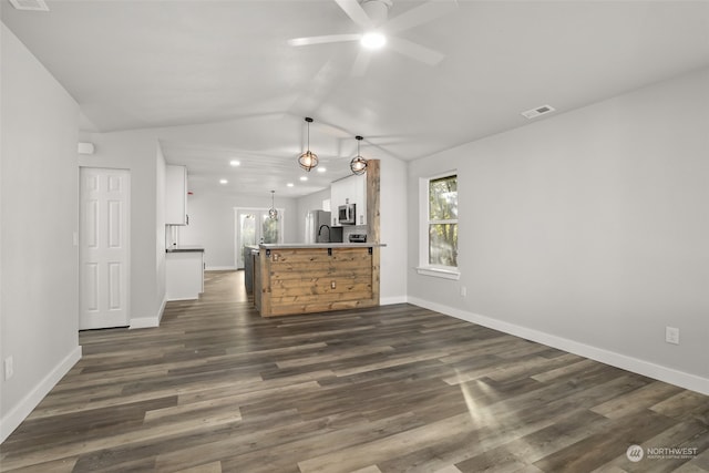 kitchen featuring white cabinets, dark hardwood / wood-style flooring, ceiling fan, and appliances with stainless steel finishes