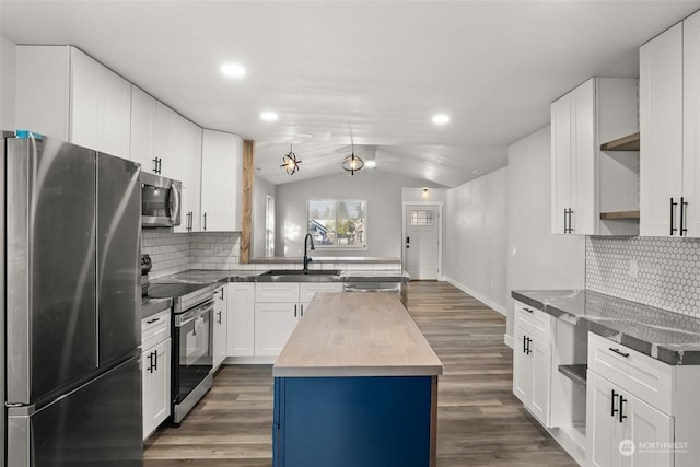 kitchen with stainless steel appliances, sink, white cabinets, lofted ceiling, and a center island