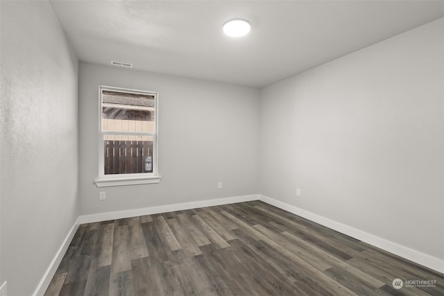 spare room with dark wood-type flooring