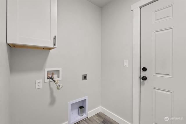 washroom with cabinets, washer hookup, electric dryer hookup, and light wood-type flooring