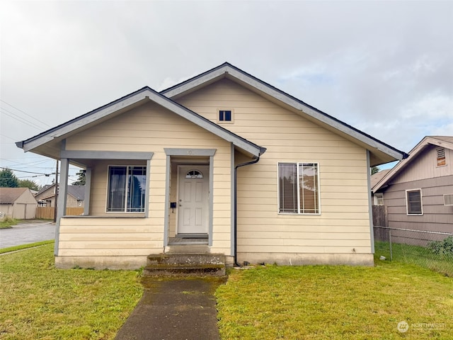 bungalow-style house with a front lawn