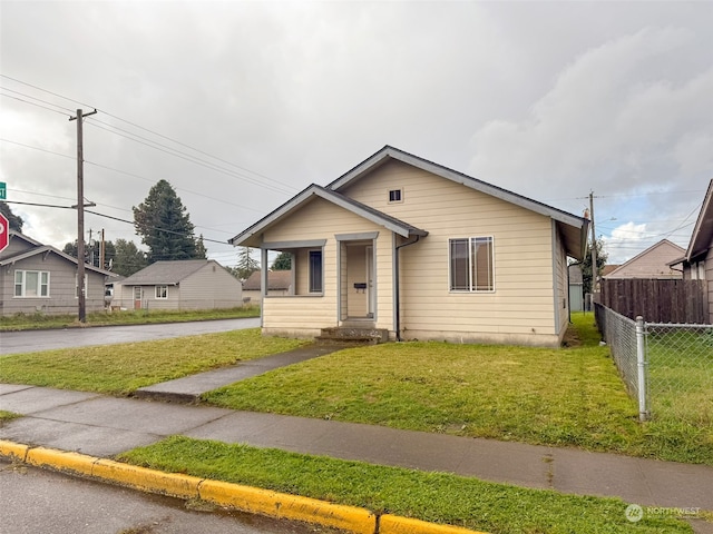 bungalow-style home featuring a front lawn