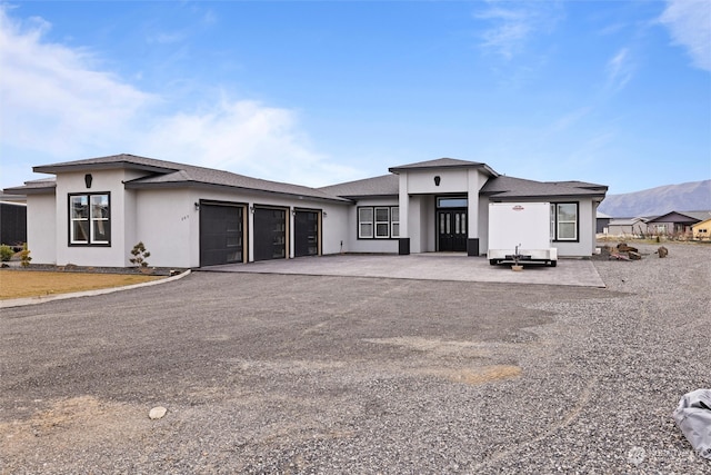 prairie-style home featuring a garage