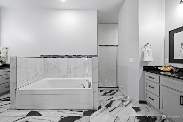 205 Clayton Pl, Mattawa, WA 99349 - full bathroom with marble look tiles, vanity, a jetted tub, and a stall shower