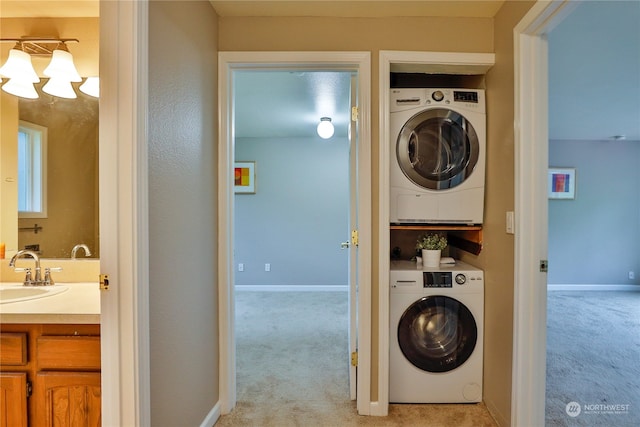 washroom featuring stacked washing maching and dryer, sink, and light colored carpet